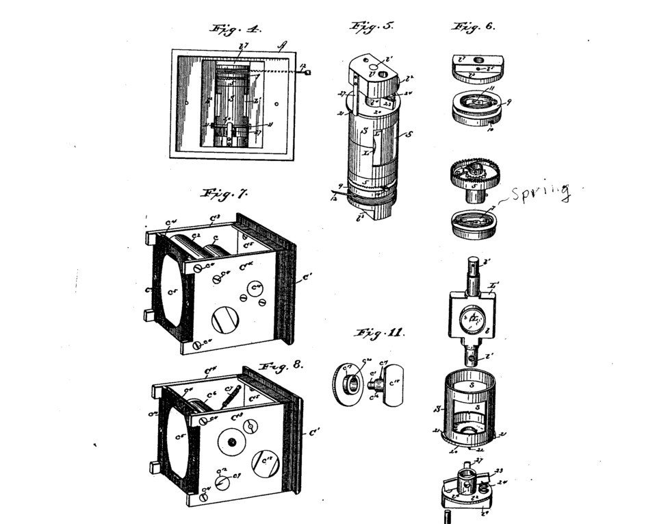 Patent drawings showing exploded views of a small box camera, a roll holder and internal gearing.