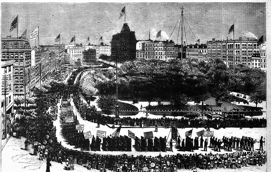 Engraving of a huge parade of marchers with banners filling a city street beside a tree filled square.