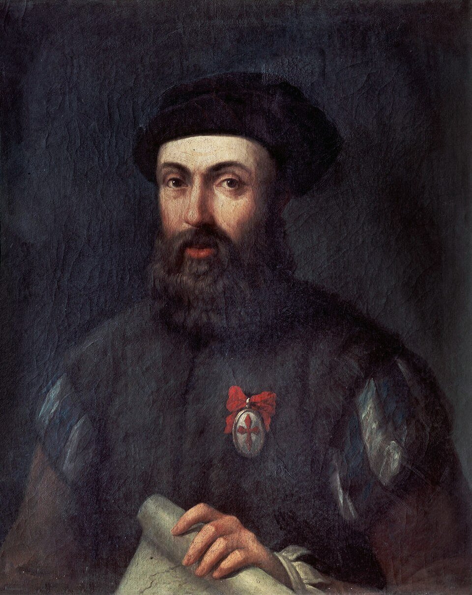 A dark oil portrait of a bearded man in a black cap with a red-ribboned badge on his chest, one hand resting on a rolled chart.