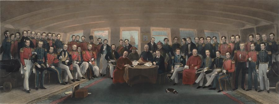Old painting of dozens of formally dressed officers and officials gathered around a table inside a ship's cabin.